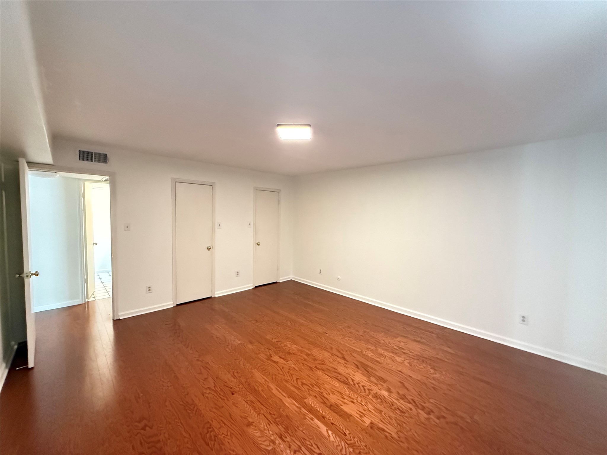 357 North Post Oak Lane, Unit 207 Houston, TX 77024 - Photo 20 of 25 a view of empty room with wooden floor