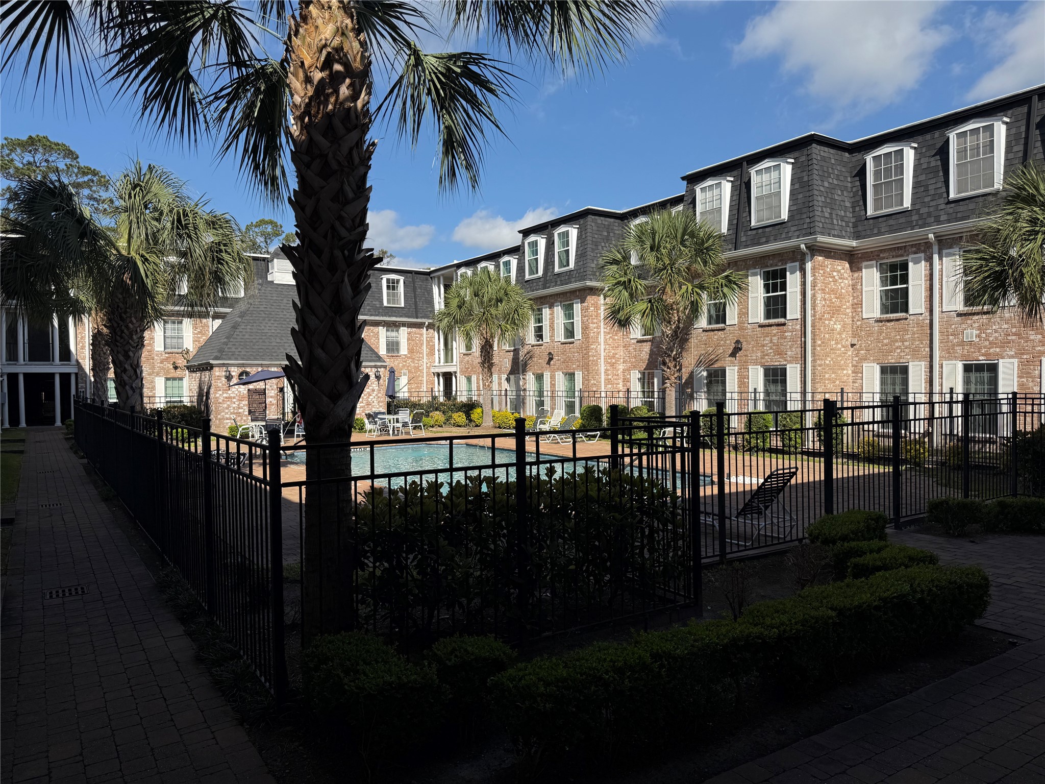 357 North Post Oak Lane, Unit 207 Houston, TX 77024 - Photo 2 of 25 a front view of a house with a garden