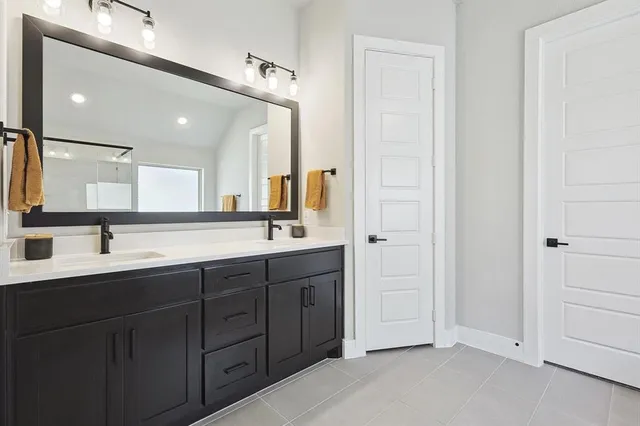 a bathroom with a tub a sink and a window