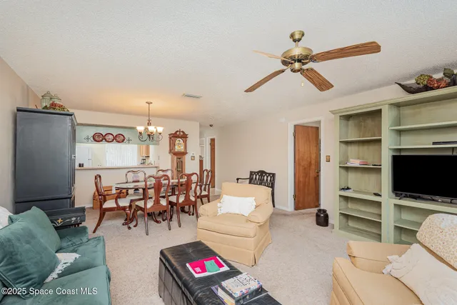 a dining room with furniture and a chandelier
