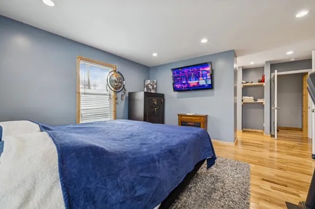 a bedroom with bed and glass cabinets