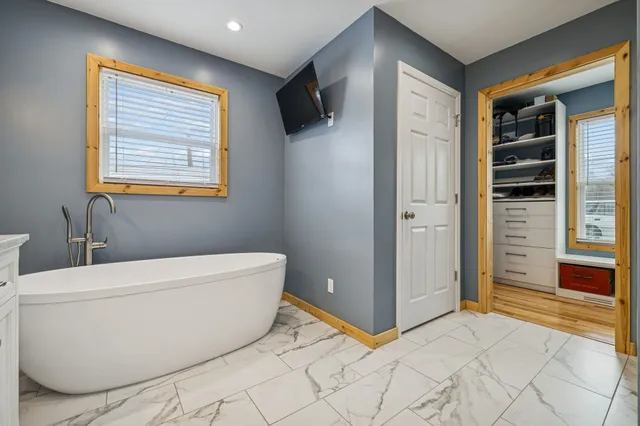 a bathroom with a bathtub and a shower
