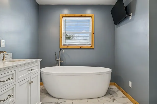 a white toilet sitting next to a bathroom sink