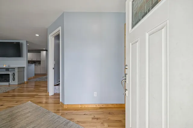 a view of a livingroom with wooden floor and a flat screen tv