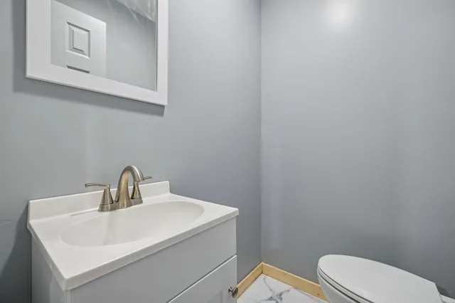 a bedroom with a bed and a refrigerator