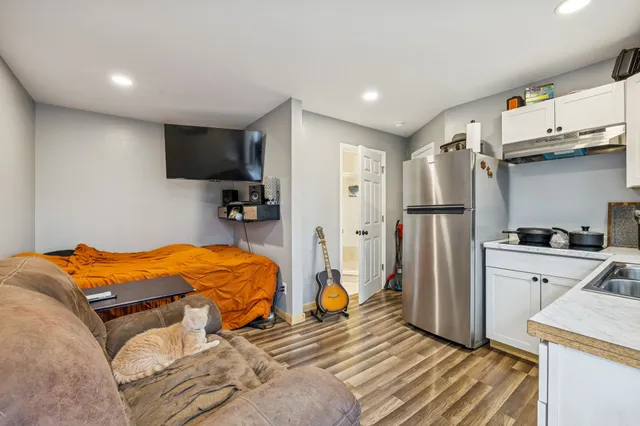 a kitchen with a refrigerator a sink and cabinets