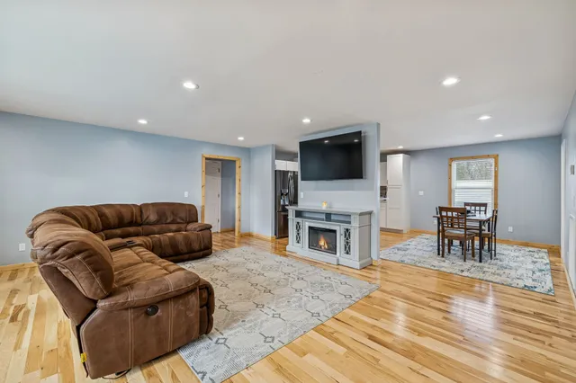 a living room with furniture a fireplace and a flat screen tv