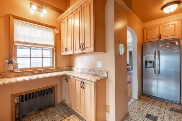 a kitchen with a stove a sink and a refrigerator