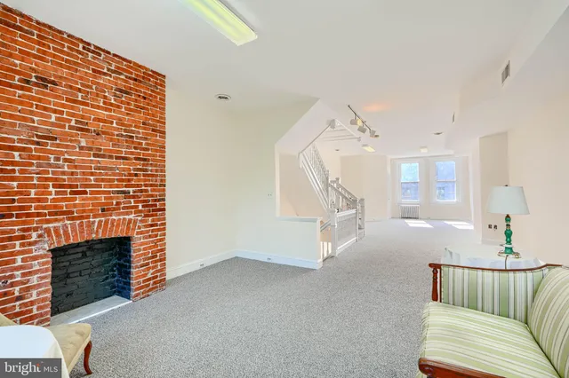 a bathroom with a toilet a sink a vanity and mirror