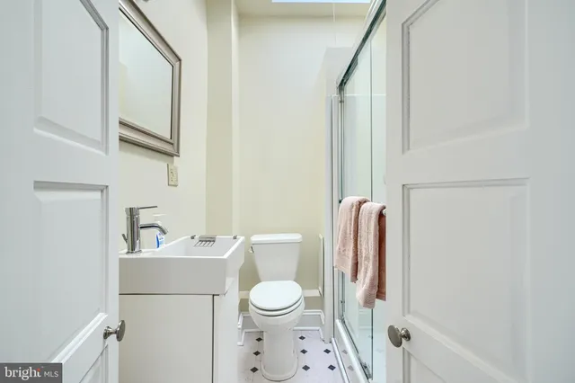a bathroom with a toilet sink and mirror