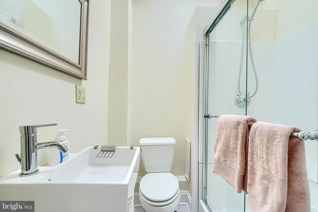 a bathroom with a glass shower door