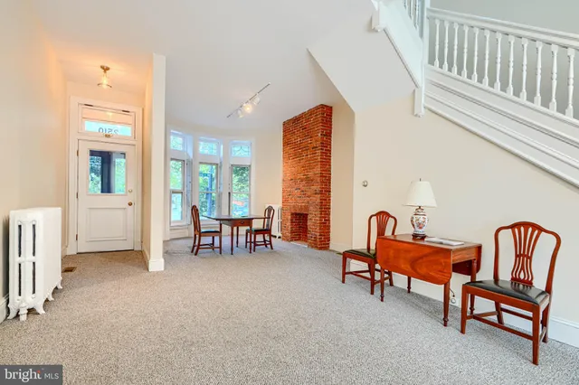 a view of a dining room with furniture and a window
