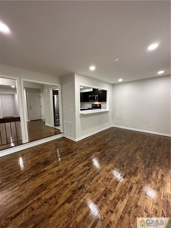 4202 Hana Road Edison, NJ 08817 - Photo 13 of 44 a view of empty room with wooden floor and window