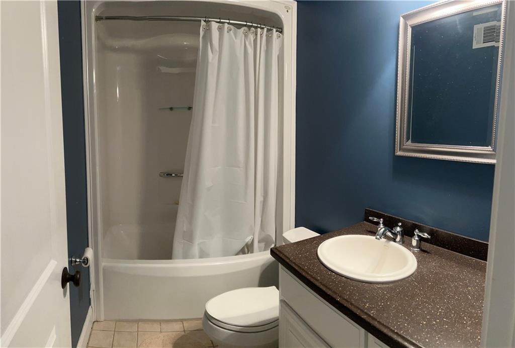 731 Jenni Lane Manchester, GA 31816 - Photo 5 of 11 a bathroom with a granite countertop sink toilet a mirror and shower