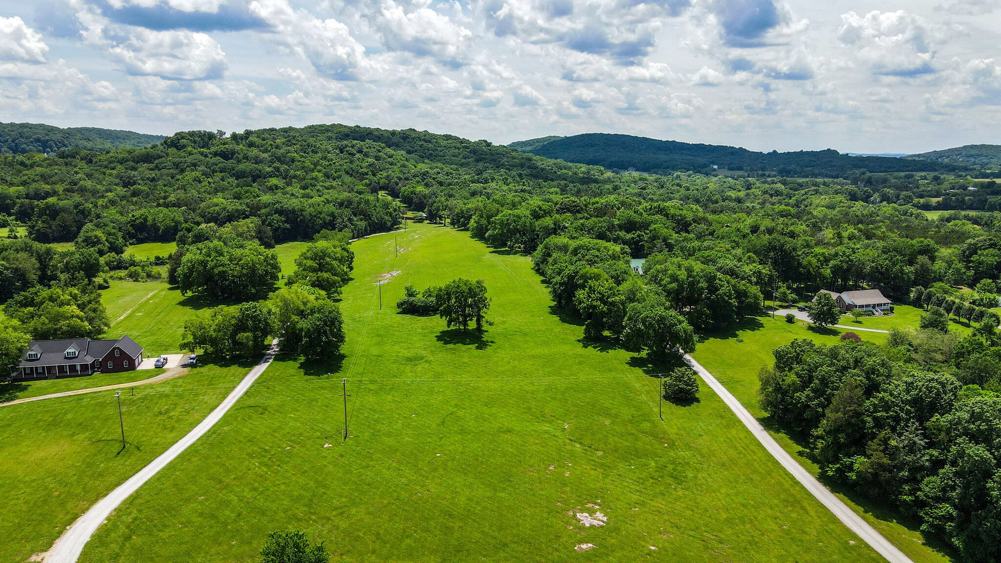 618 Greenvale Road Lebanon, TN 37090 - Photo 2 of 48 a view of a lush green hillside and a houses