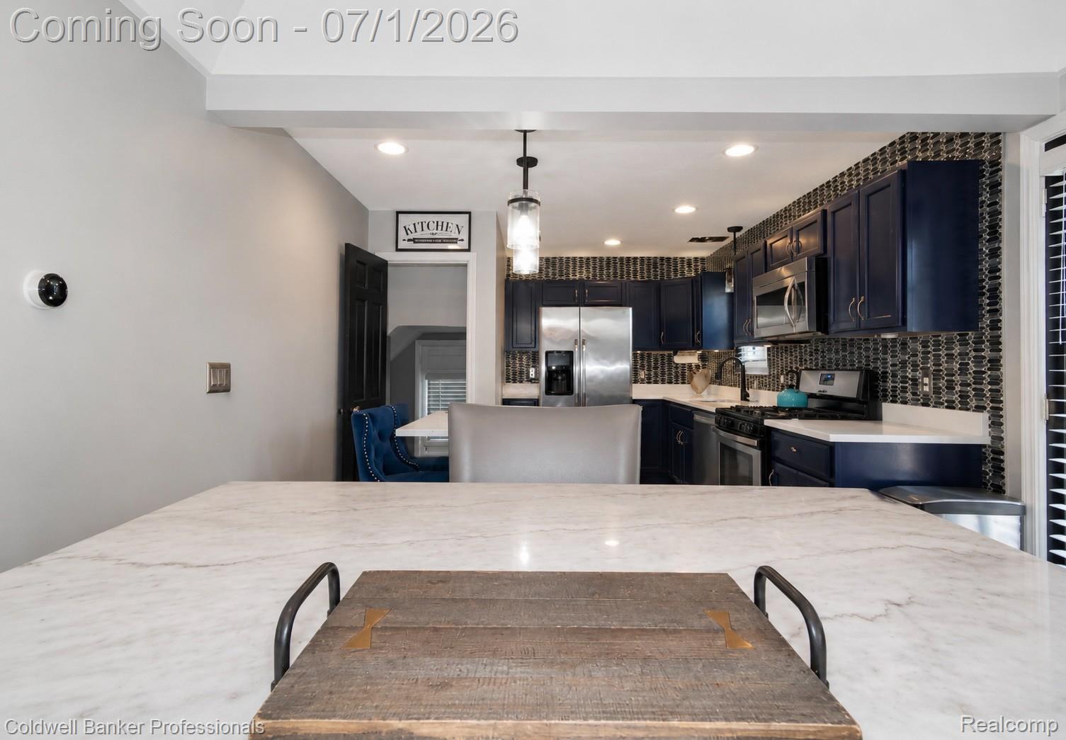 1168 Vernier Road Grosse Pointe, MI 48236 - Photo 10 of 32 Kitchen featuring dark blue cabinetry, stainless steel appliances, a mosaic tile backsplash, white countertops, and recessed lighting