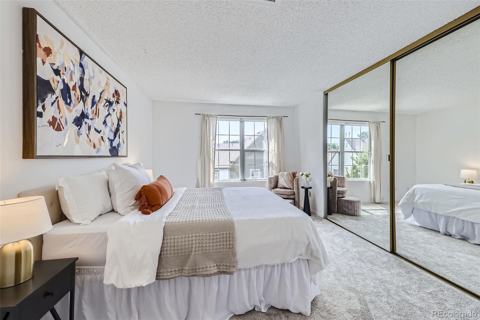 1811 South Quebec Way, Unit 244 Denver, CO 80231 - Photo 15 of 25 a bedroom with a large bed and a window with outer view