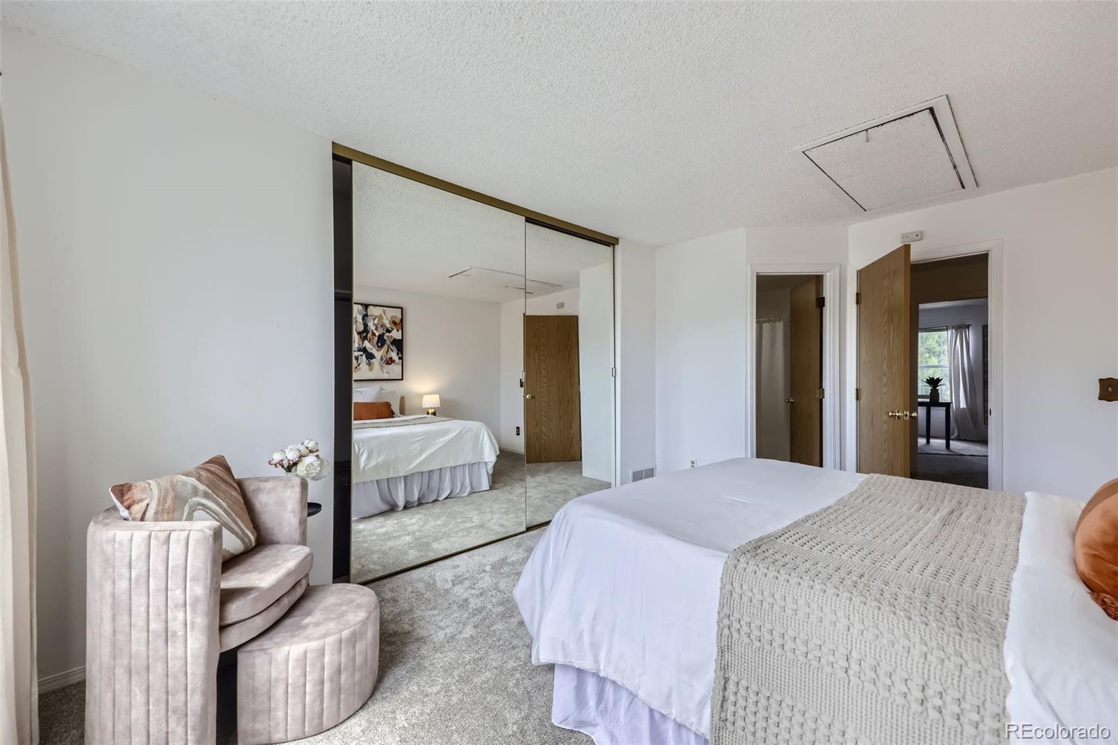 1811 South Quebec Way, Unit 244 Denver, CO 80231 - Photo 16 of 25 a bedroom with a bed and a couch