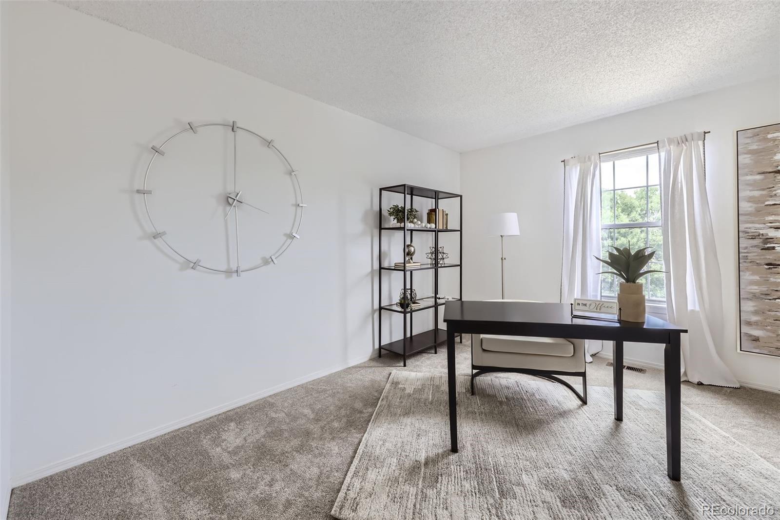 1811 South Quebec Way, Unit 244 Denver, CO 80231 - Photo 19 of 25 a view of a livingroom with furniture and window