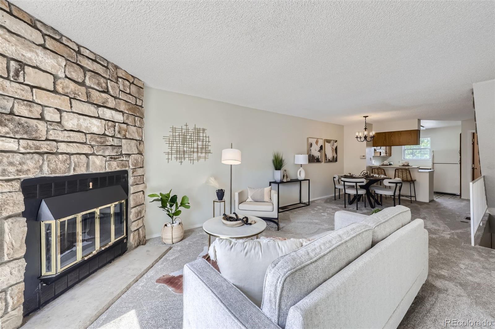 1811 South Quebec Way, Unit 244 Denver, CO 80231 - Photo 4 of 25 a living room with furniture and a fireplace