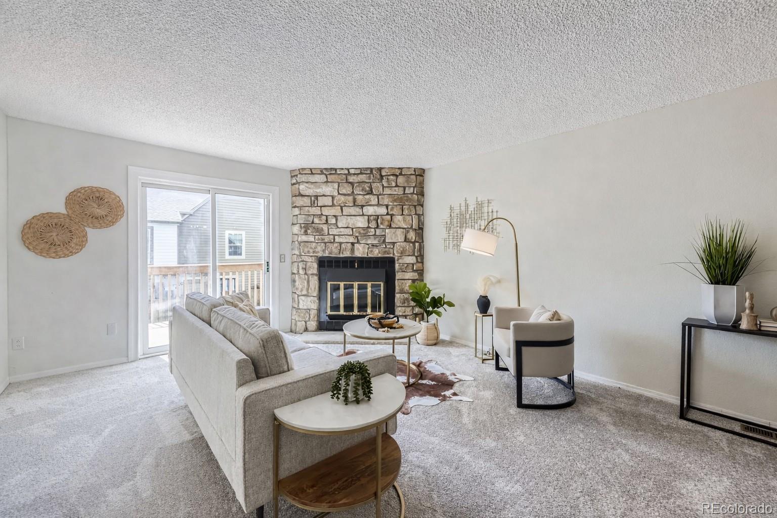 1811 South Quebec Way, Unit 244 Denver, CO 80231 - Photo 5 of 25 a living room with furniture and a fireplace