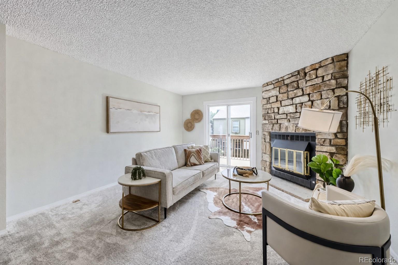 1811 South Quebec Way, Unit 244 Denver, CO 80231 - Photo 6 of 25 a living room with furniture and a potted plant