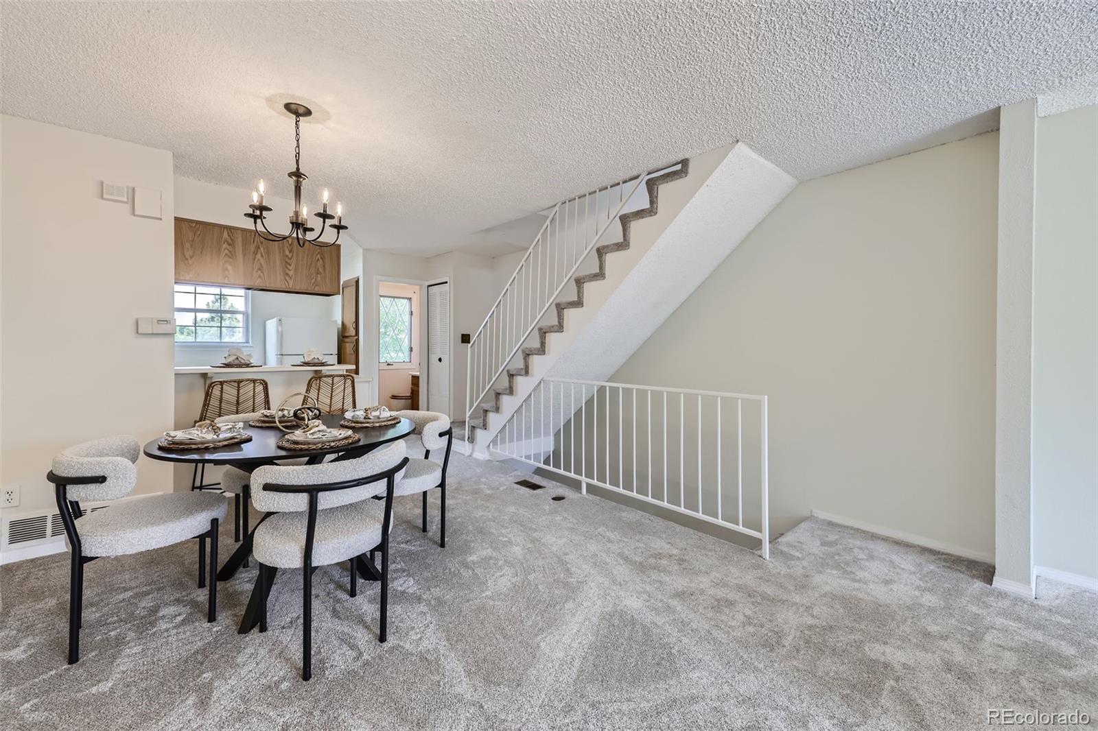 1811 South Quebec Way, Unit 244 Denver, CO 80231 - Photo 8 of 25 a view of a dining room with furniture