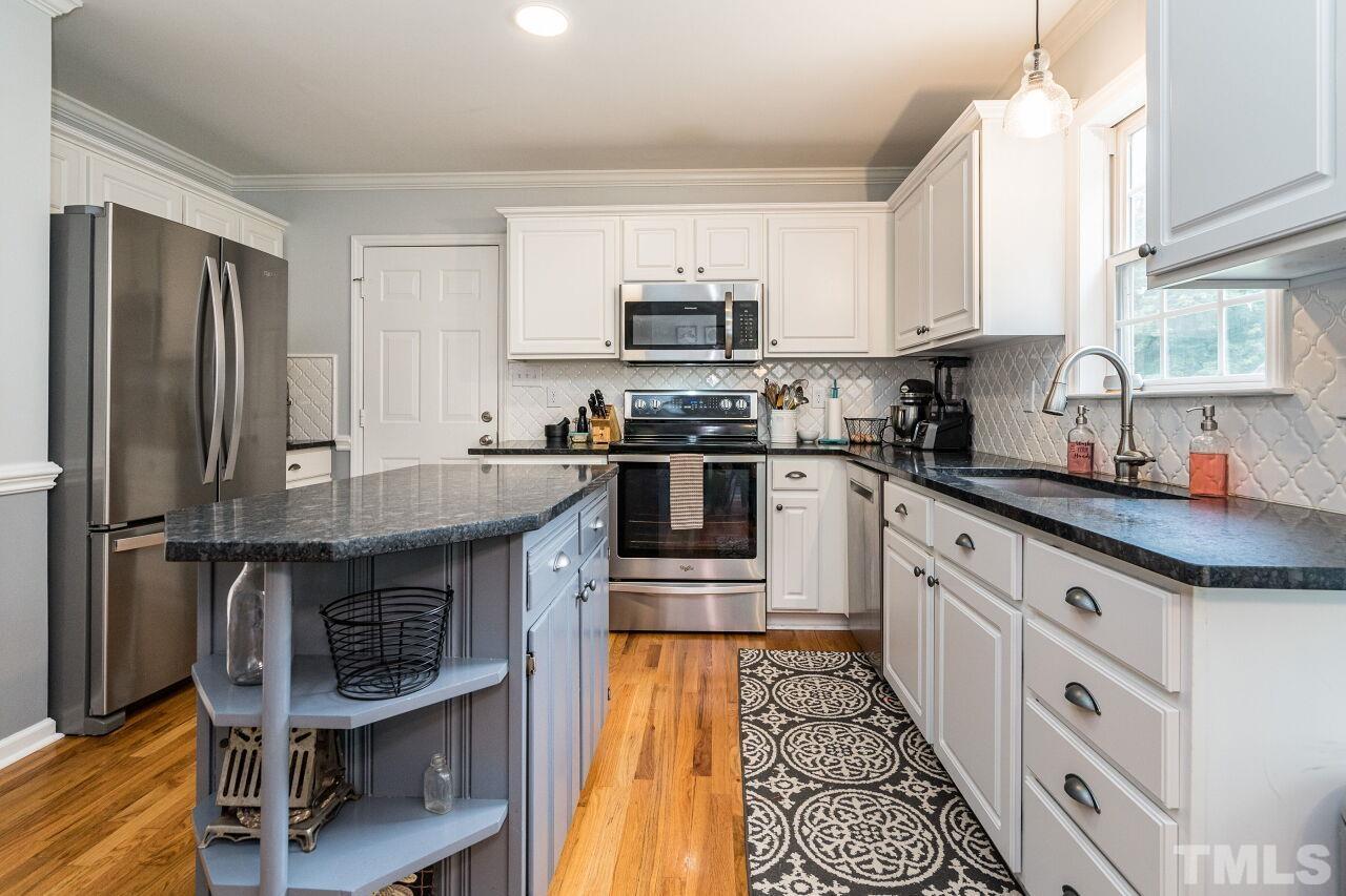 1037 Red Brick Road Garner, NC 27529 - Photo 11 of 33 a kitchen with granite countertop a sink stove and refrigerator