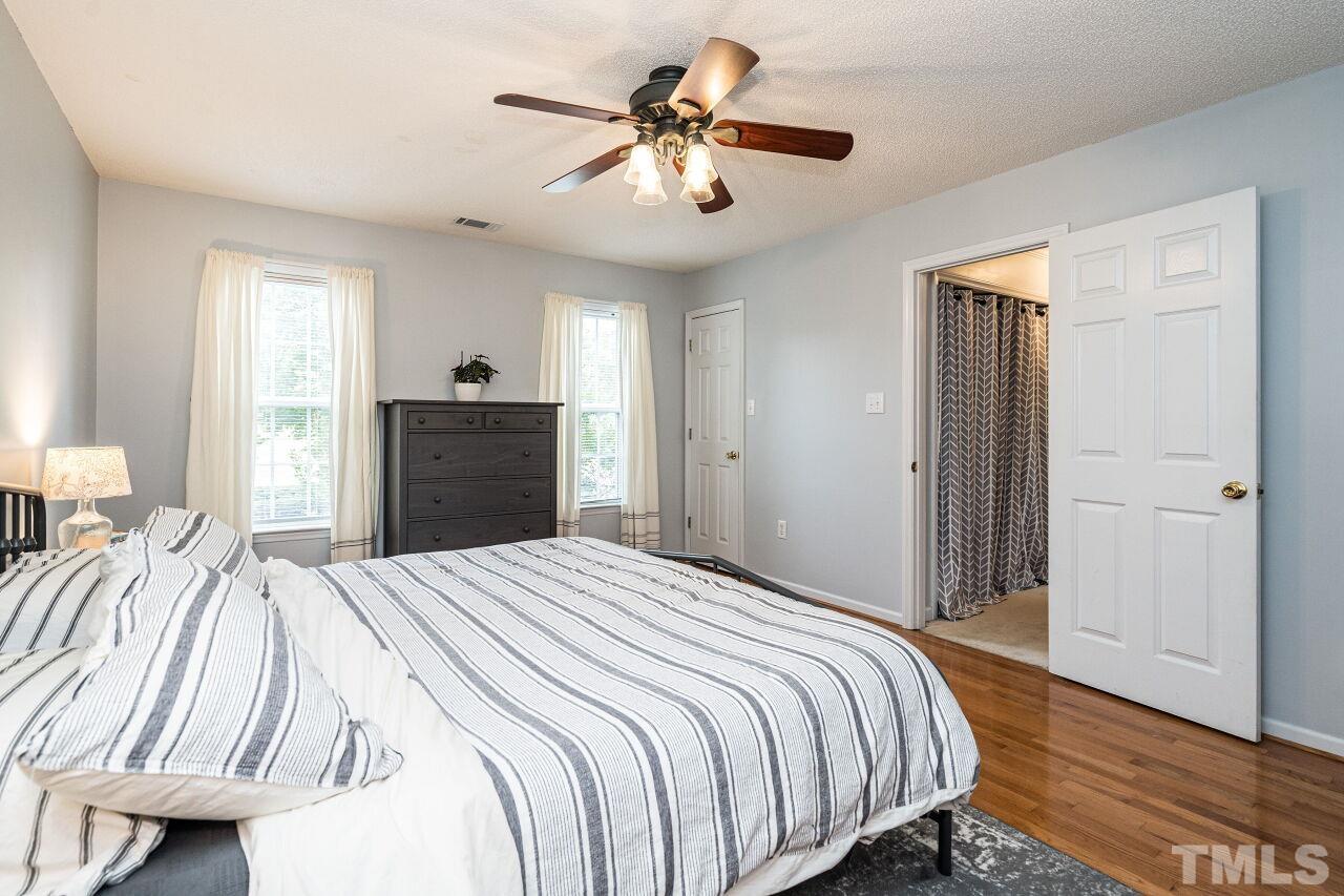 1037 Red Brick Road Garner, NC 27529 - Photo 15 of 33 a bedroom with a bed and a chandelier