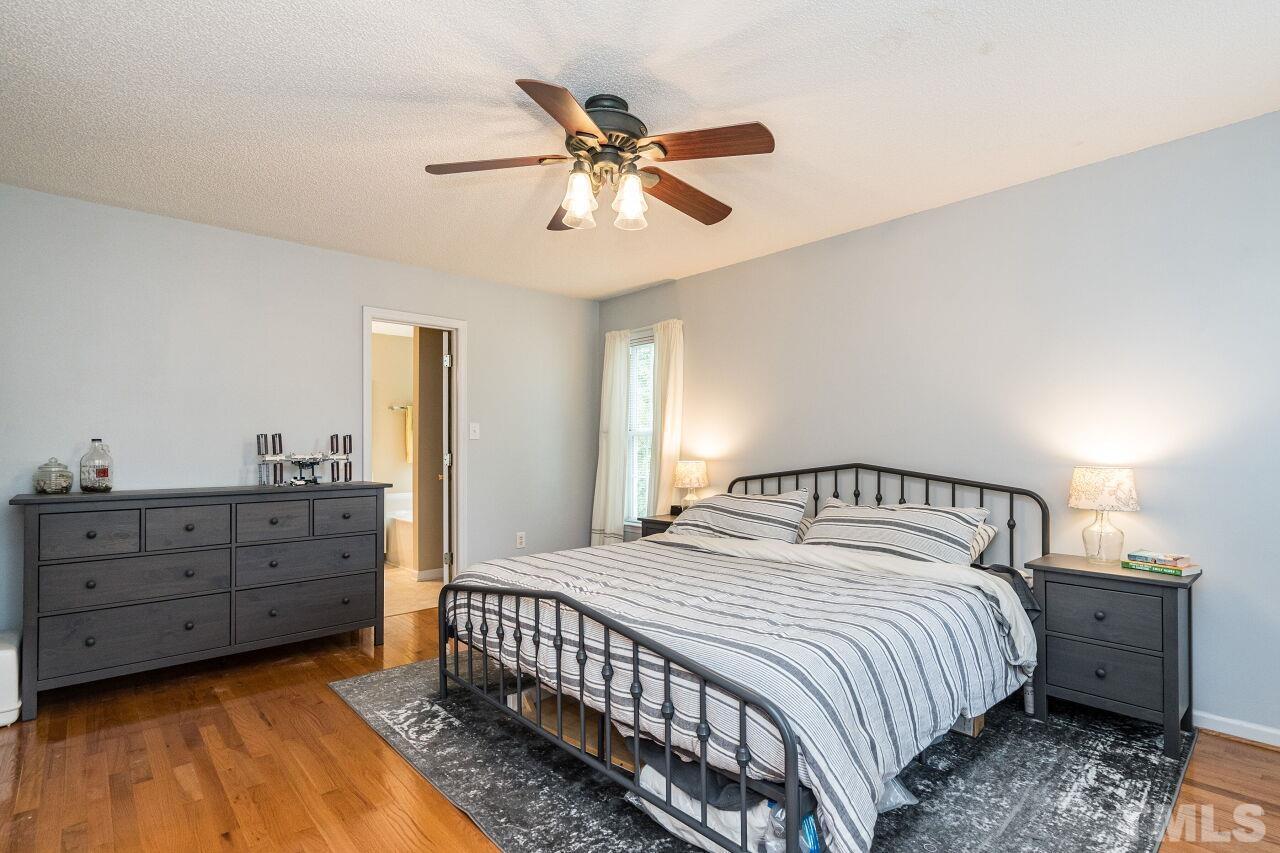 1037 Red Brick Road Garner, NC 27529 - Photo 16 of 33 a bedroom with a bed and a chandelier