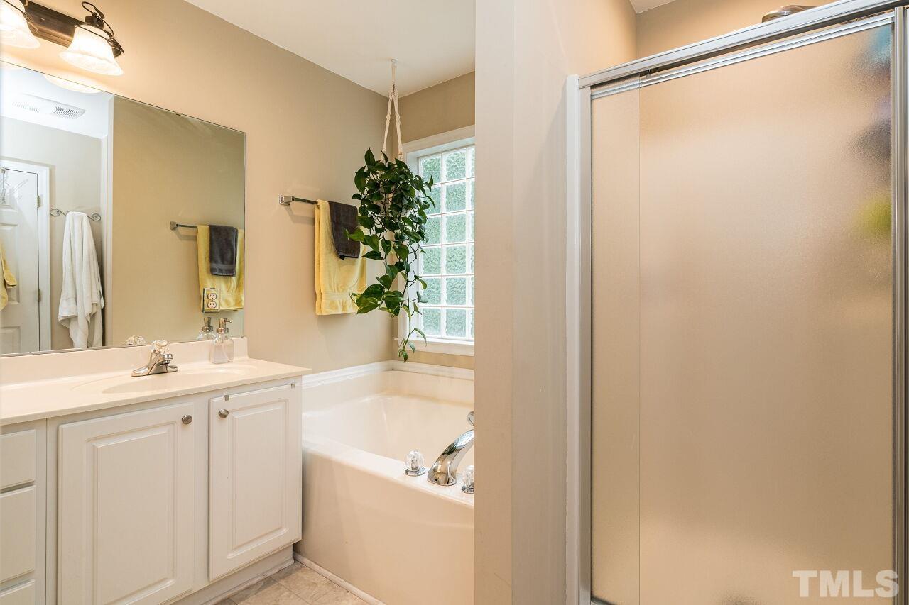 1037 Red Brick Road Garner, NC 27529 - Photo 18 of 33 a bathroom with a granite countertop sink and a mirror