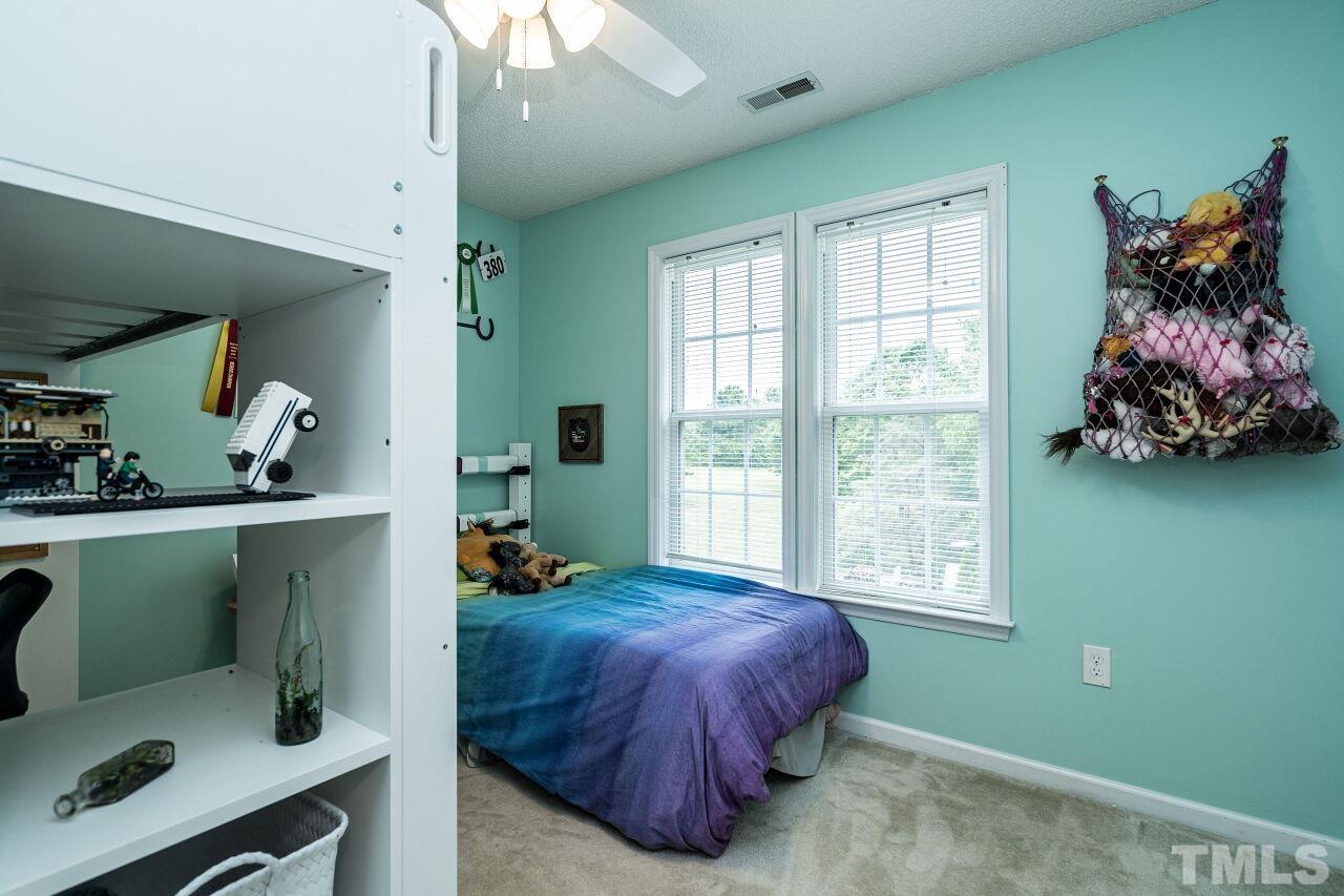 1037 Red Brick Road Garner, NC 27529 - Photo 19 of 33 a bed room with a bed and a window