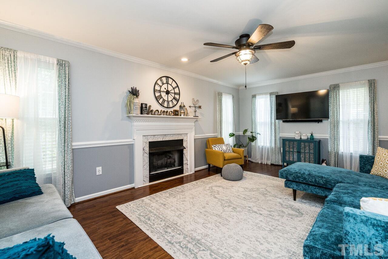 1037 Red Brick Road Garner, NC 27529 - Photo 7 of 33 a living room with furniture a fireplace and a flat screen tv
