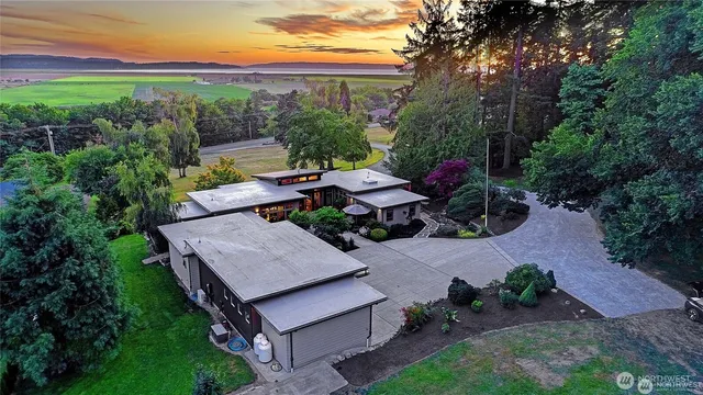 an aerial view of a house with garden space and street view