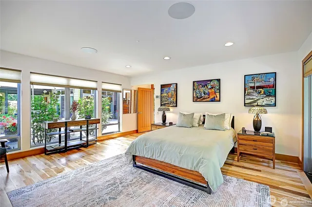 a spacious bedroom with a bed and a large window