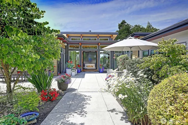 a view of a patio with a table and chairs under an umbrella