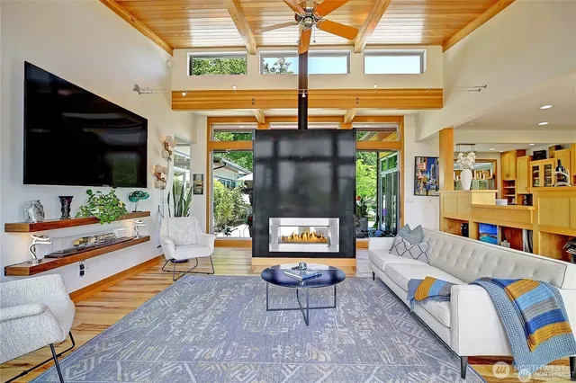 a living room with patio furniture and a flat screen tv
