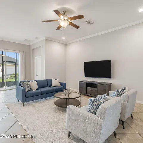a living room with furniture and a flat screen tv