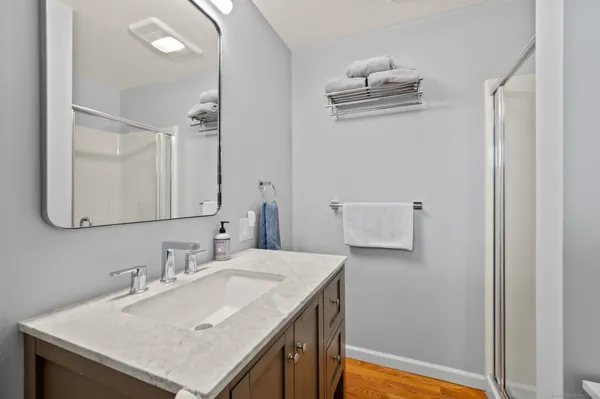 a bathroom with a sink vanity and a mirror