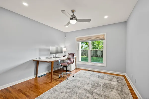 a workspace with wooden floor and a window