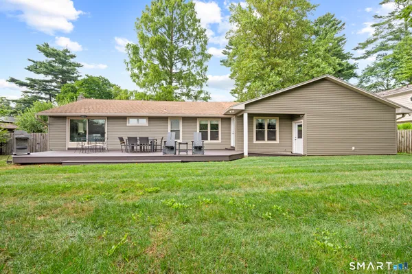 a front view of a house with yard and green space