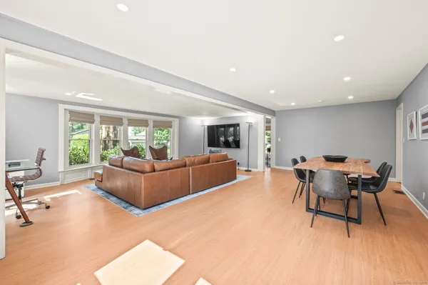 a living room with furniture a large window and a table