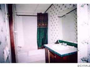 5000 Ontario Road Keysville, VA 23947 - Photo 5 of 10 a bathroom with a sink and a mirror