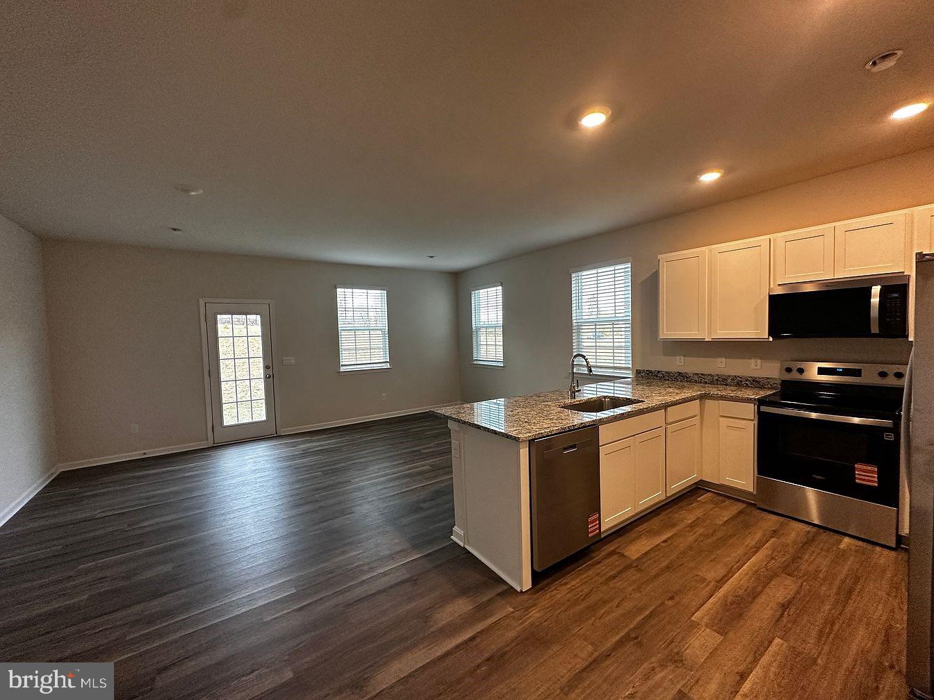 163 Rae Court Luray, VA 22835 - Photo 13 of 13 a large kitchen with wooden floors and stainless steel appliances