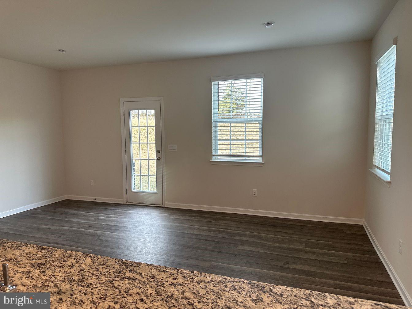 163 Rae Court Luray, VA 22835 - Photo 4 of 13 an empty room with wooden floor and windows