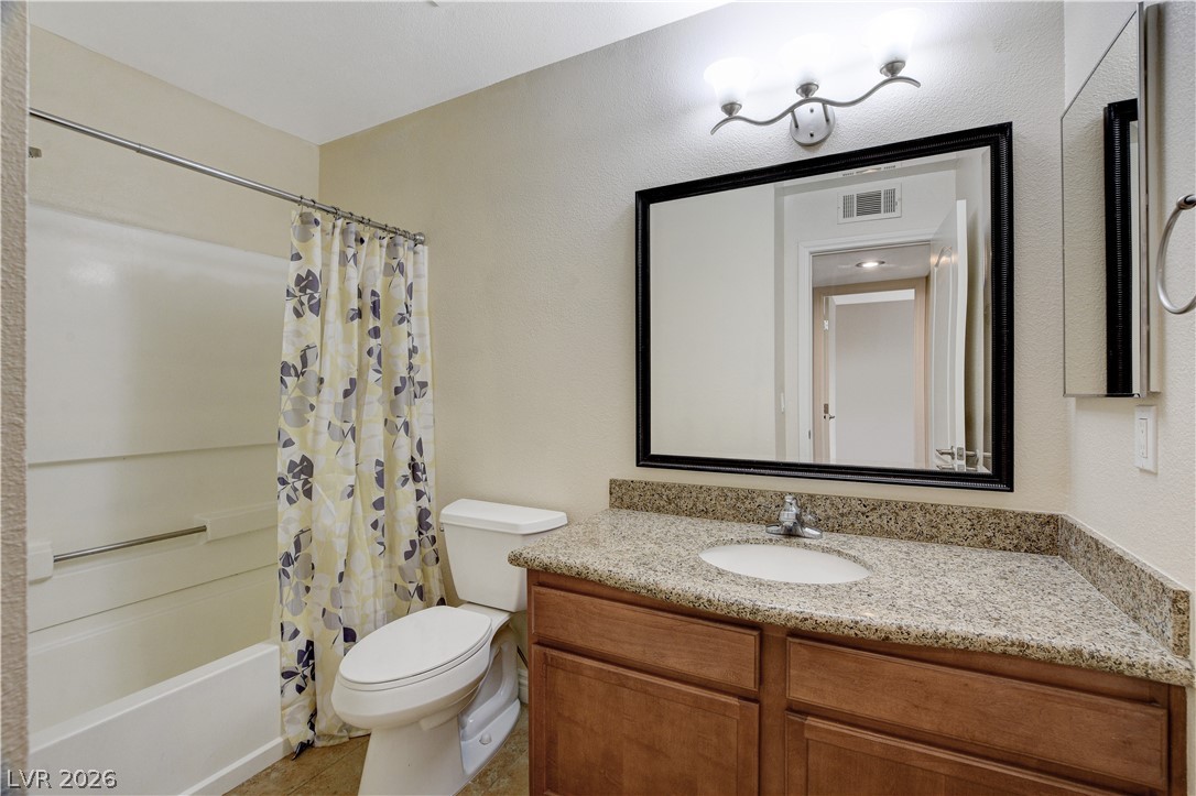 7200 West Pirates Cove Road, Unit 1026 Las Vegas, NV 89145 - Photo 17 of 35 This bathroom features a sleek vanity with ample counter space and a classic tub-shower combination.