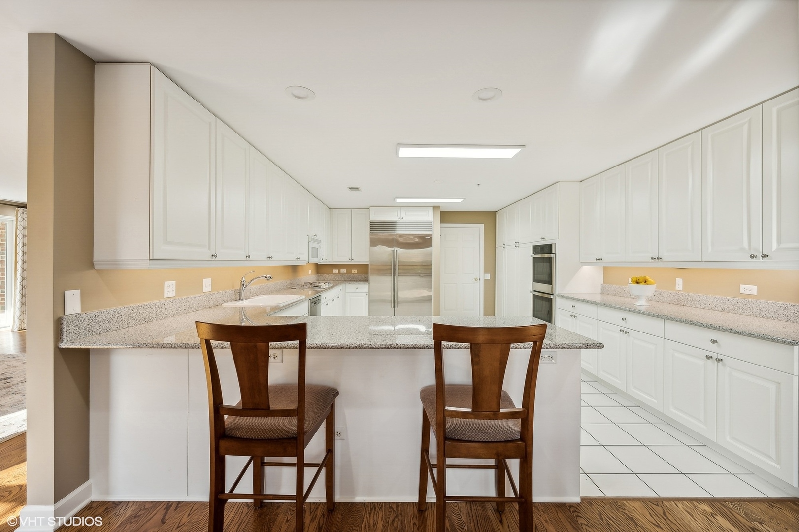 360 Green Bay Road, Unit 3D Winnetka, IL 60093 - Photo 15 of 30 a kitchen with stainless steel appliances cabinets dining table and chairs