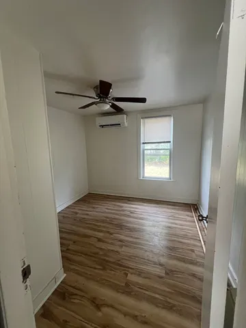 a view of an empty room and a window