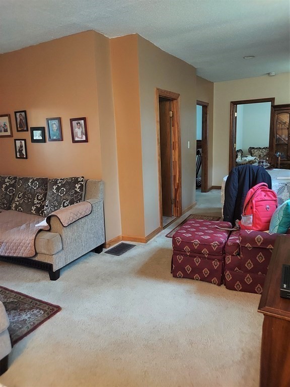 30 Carver Street Fall River, MA 02721 - Photo 7 of 19 a spacious bedroom with a bed and a couch