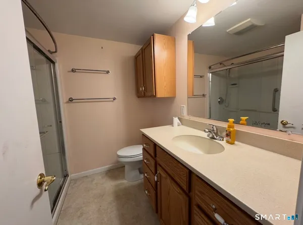 a bathroom with a sink a toilet and a mirror